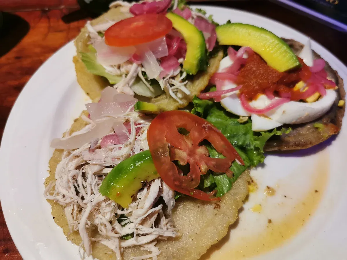 Panuchos and salbutes, the fried-tortilla snacks eaten across the Yucatán and in Tulum town, Mexico